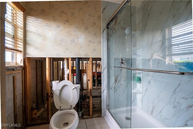 bathroom with tile patterned flooring, toilet, an enclosed shower, and a healthy amount of sunlight