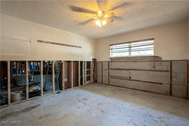 interior space with ceiling fan and a textured ceiling