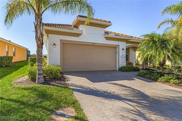 mediterranean / spanish house with a garage