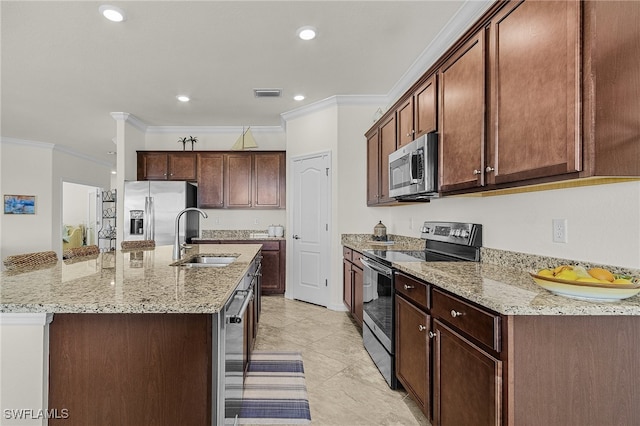 kitchen featuring sink, light stone counters, a center island with sink, appliances with stainless steel finishes, and ornamental molding