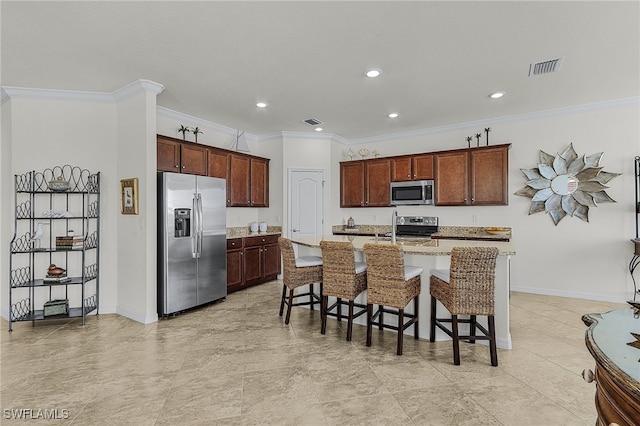 kitchen with a kitchen bar, a center island with sink, ornamental molding, and appliances with stainless steel finishes