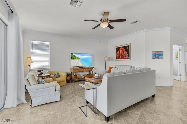 tiled living room with ceiling fan and crown molding