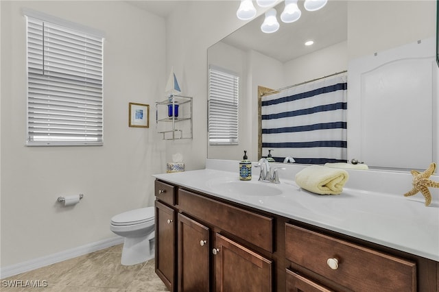 bathroom with vanity, toilet, and walk in shower