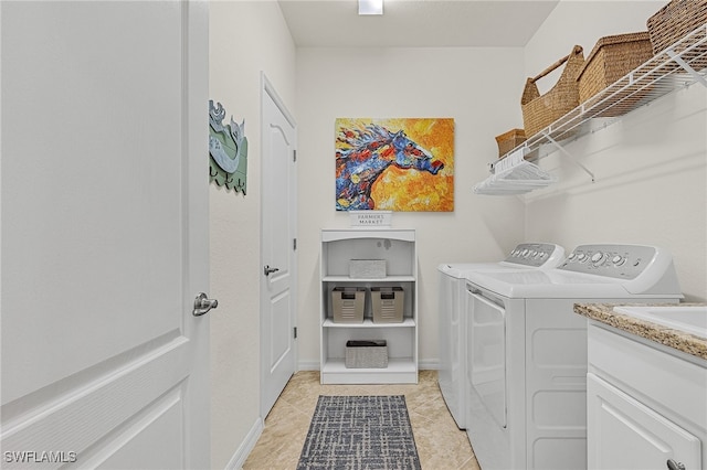 washroom with separate washer and dryer and light tile patterned floors