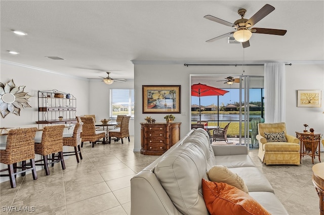 tiled living room featuring crown molding and a water view