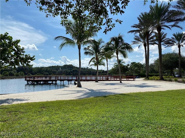 view of home's community with a lawn and a water view