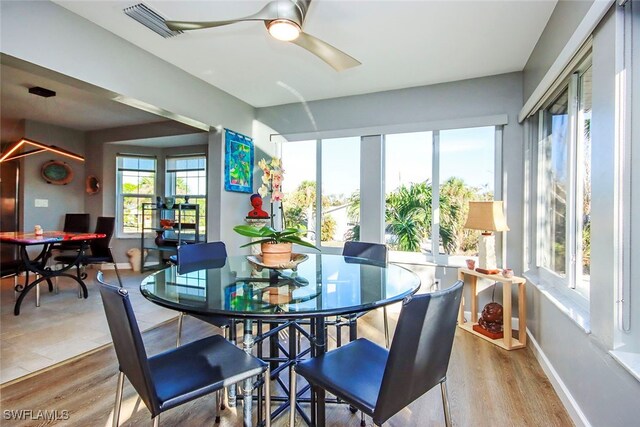 sunroom / solarium featuring ceiling fan