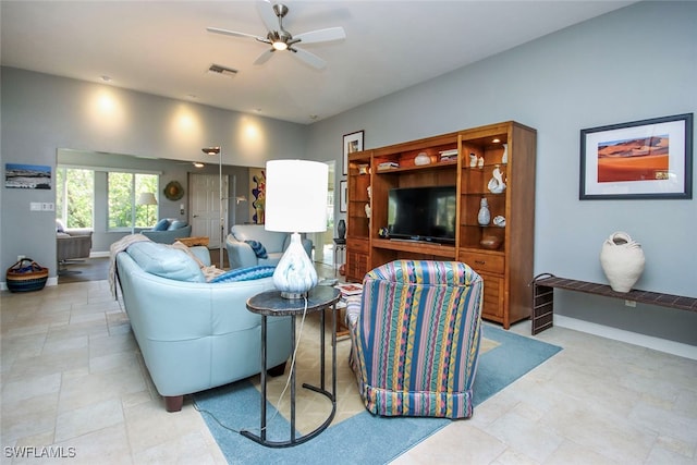 living room featuring ceiling fan and light tile patterned flooring