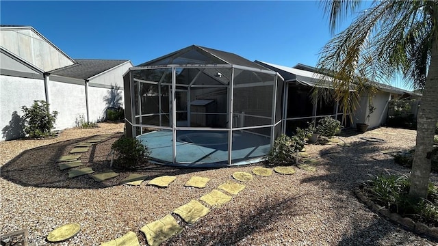 18409 Orangecrest Ct, Lehigh Acres, FL 33936 - rear view of house with an outdoor pool, a patio area, stucco siding, and a lanai