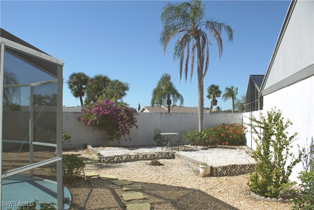 view of patio featuring glass enclosure