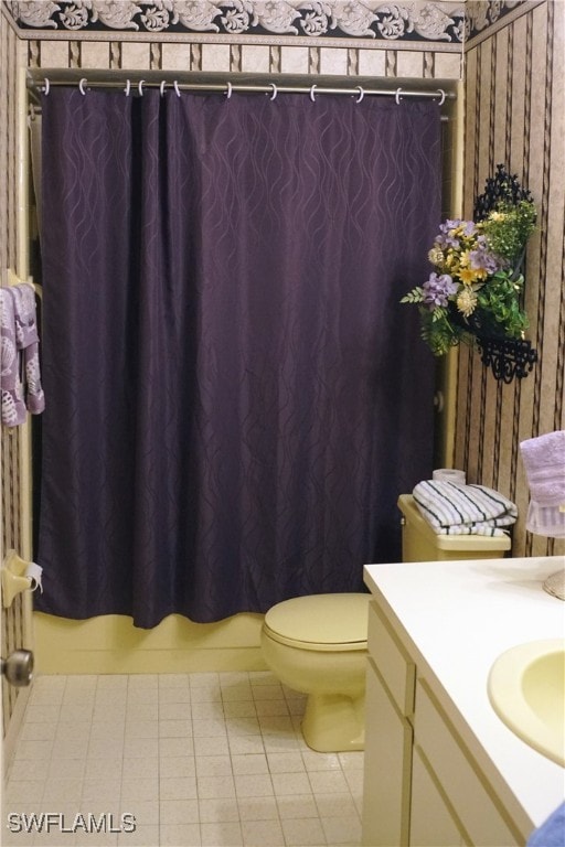 bathroom featuring tile patterned floors, vanity, and toilet