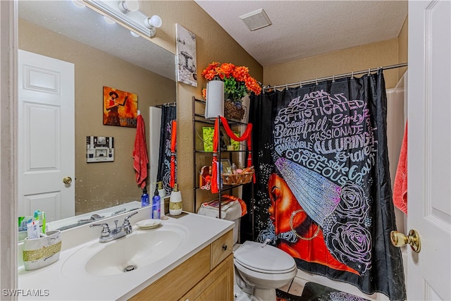 bathroom with vanity, a textured ceiling, tile patterned flooring, toilet, and curtained shower