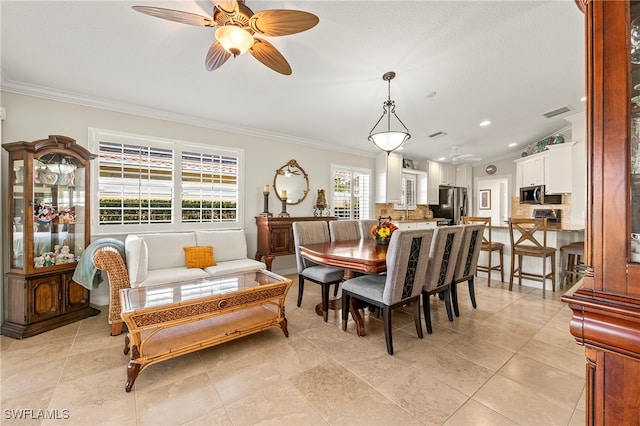 dining room featuring ceiling fan, ornamental molding, light tile patterned floors, and lofted ceiling