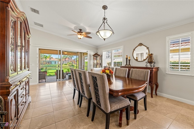 tiled dining space with crown molding, ceiling fan, and lofted ceiling