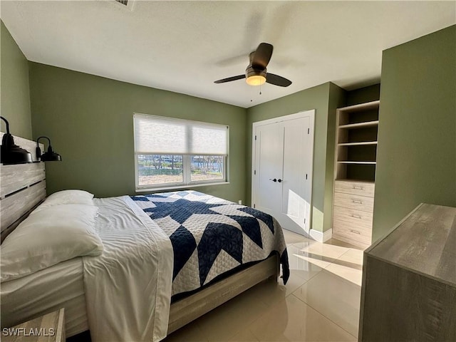 tiled bedroom featuring ceiling fan