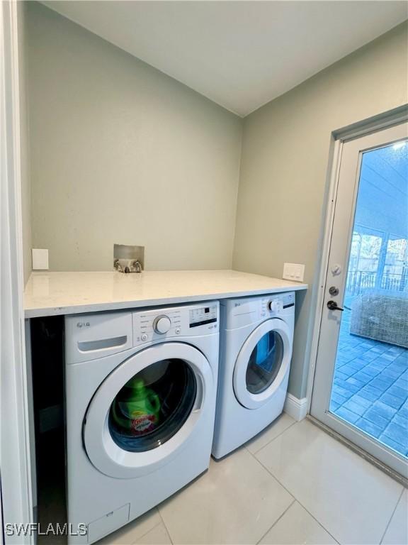 laundry room with separate washer and dryer and light tile patterned floors