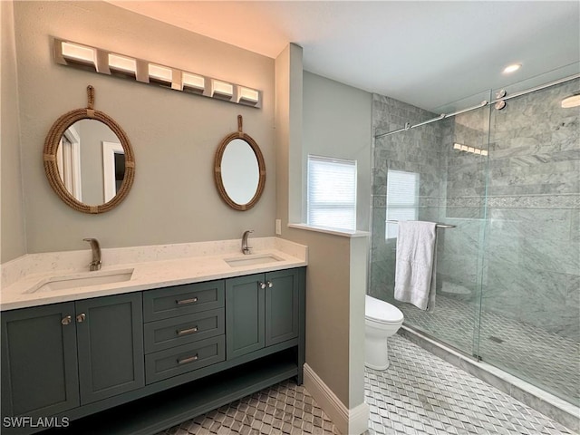 bathroom with vanity, tile patterned flooring, a shower with shower door, and toilet