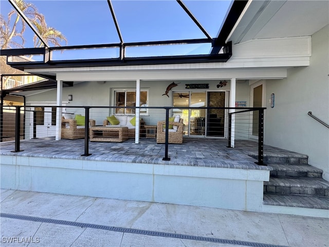 exterior space featuring an outdoor hangout area and glass enclosure