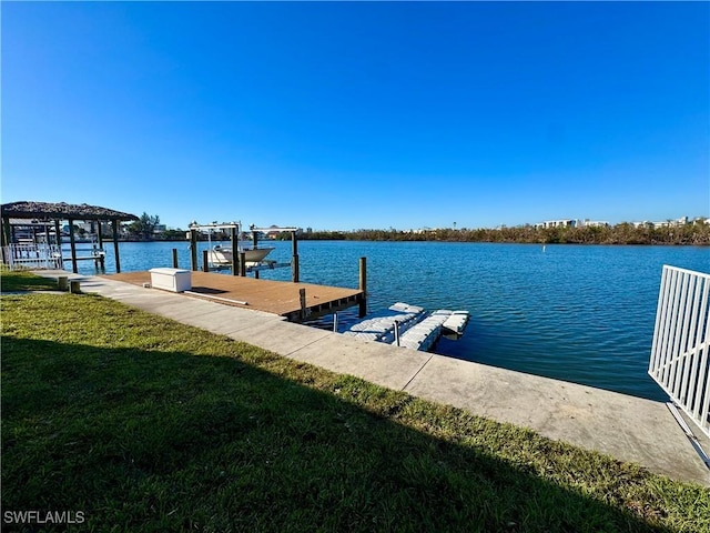 view of dock featuring a water view and a yard