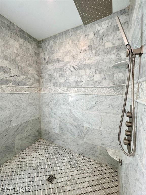 bathroom with tiled shower