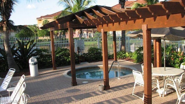 view of swimming pool with a patio, a pergola, and a hot tub