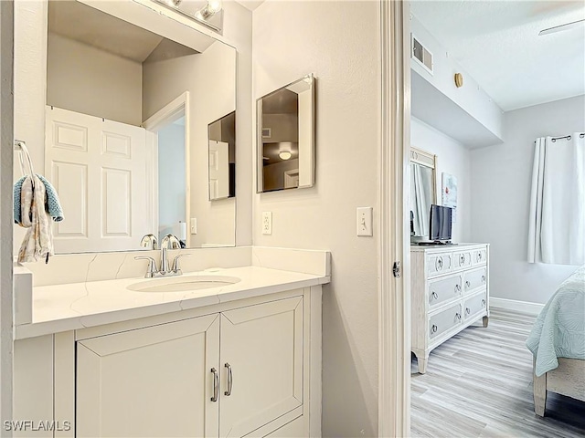 bathroom featuring hardwood / wood-style floors and vanity