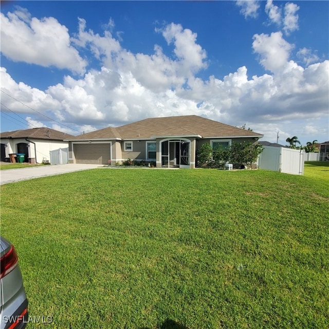 view of front of house with a front yard and a garage