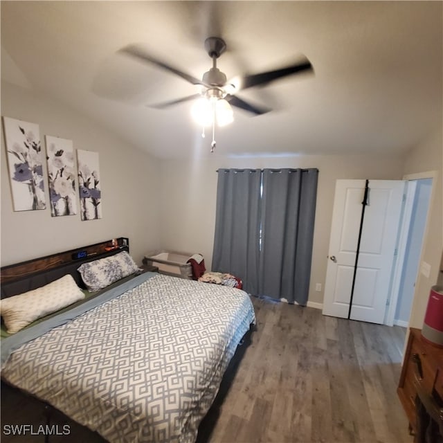 bedroom featuring ceiling fan, light hardwood / wood-style flooring, and lofted ceiling