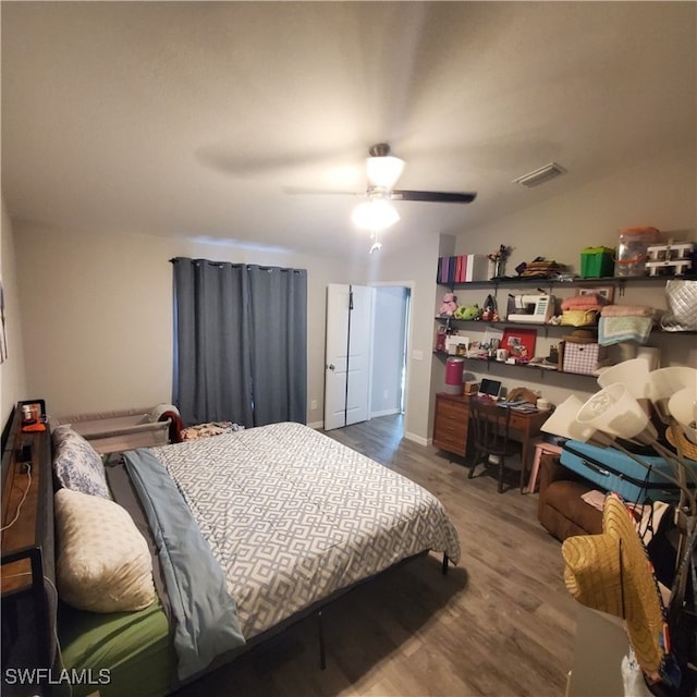 bedroom with hardwood / wood-style flooring, ceiling fan, and lofted ceiling