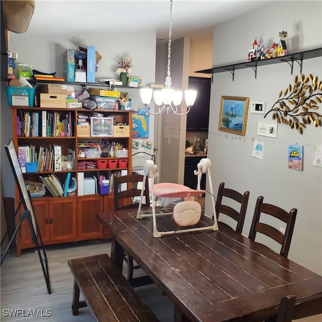 dining room featuring hardwood / wood-style floors and a notable chandelier