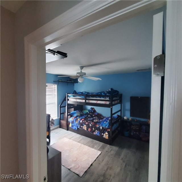 bedroom featuring hardwood / wood-style floors and ceiling fan