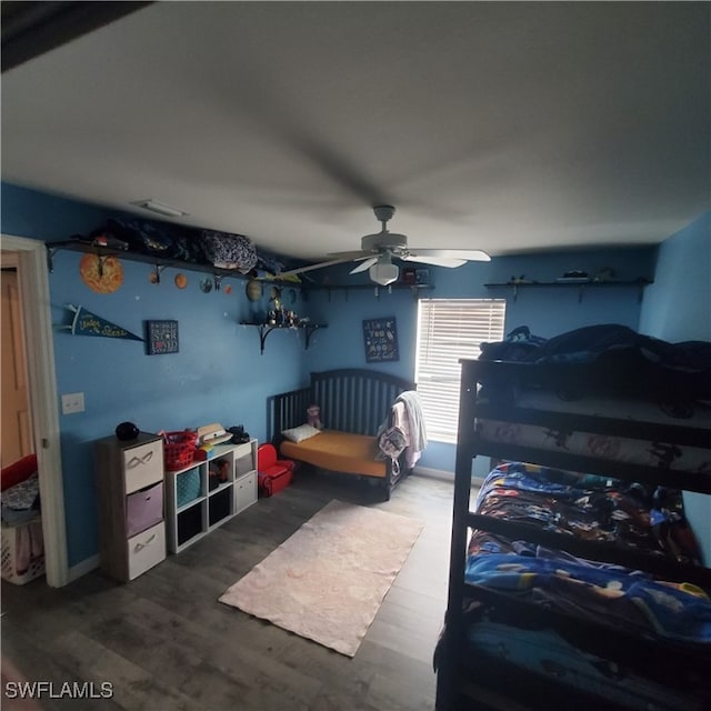 bedroom with ceiling fan and wood-type flooring