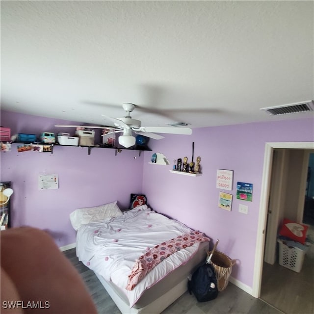 bedroom featuring hardwood / wood-style flooring and ceiling fan