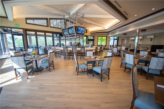 dining area featuring french doors, vaulted ceiling, and light hardwood / wood-style flooring