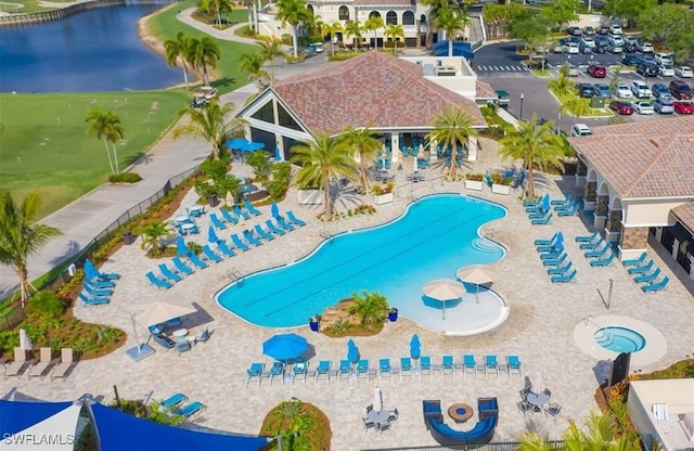 view of pool with a patio area and a water view