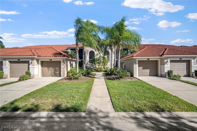 mediterranean / spanish-style house featuring a garage and a front yard