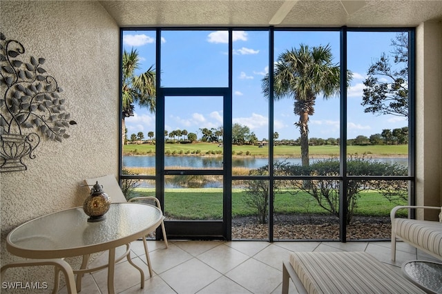 sunroom / solarium featuring a water view