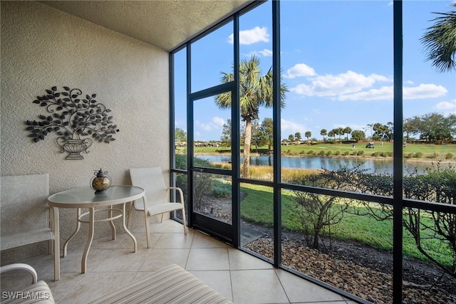 sunroom / solarium featuring a water view