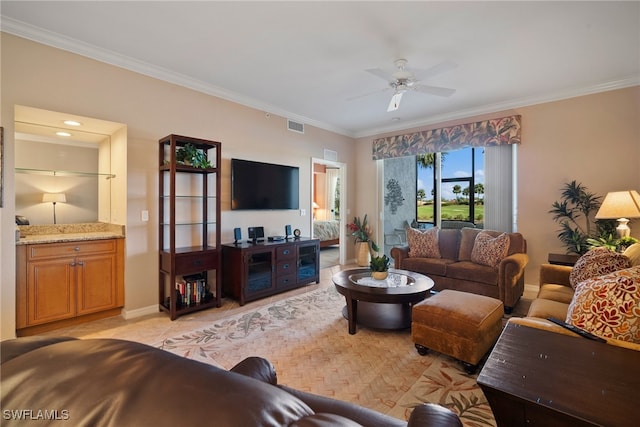 living room featuring ceiling fan, light tile patterned floors, and ornamental molding