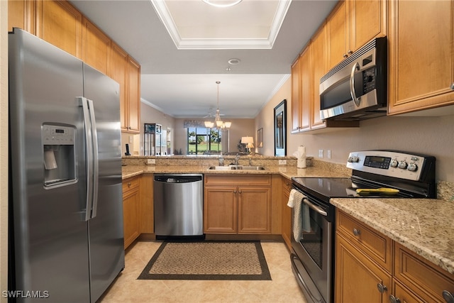 kitchen with kitchen peninsula, appliances with stainless steel finishes, ornamental molding, sink, and a notable chandelier