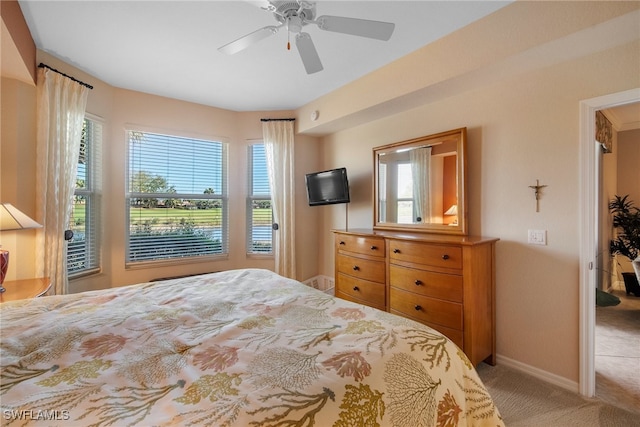 bedroom featuring carpet flooring, multiple windows, and ceiling fan