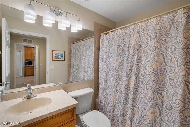 bathroom with a shower with curtain, vanity, and toilet