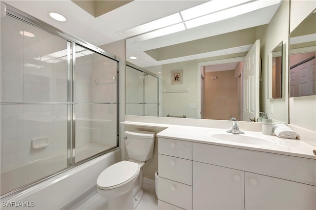 full bathroom with vanity, toilet, and shower / bath combination with glass door