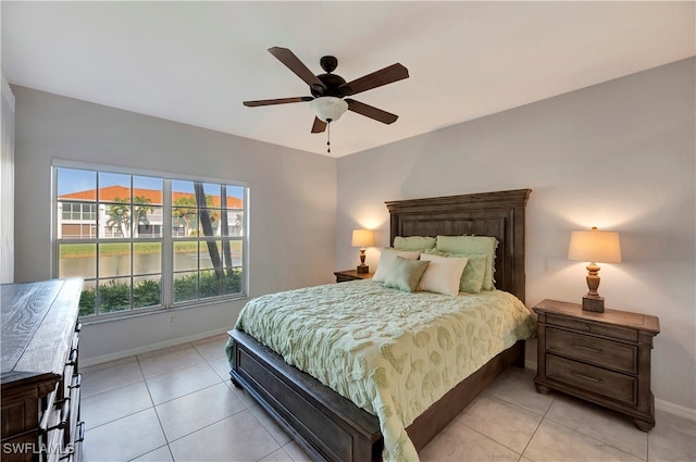 tiled bedroom featuring ceiling fan