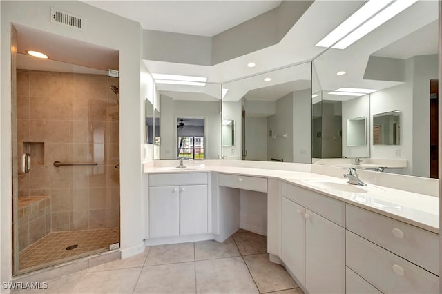 bathroom with tile patterned flooring, vanity, and walk in shower