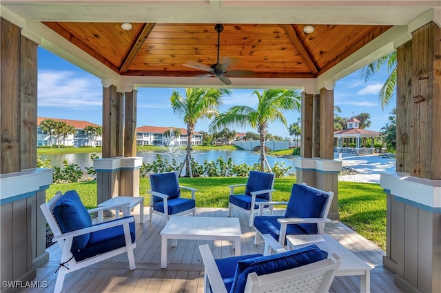 view of patio with a gazebo, an outdoor living space, a water view, and ceiling fan