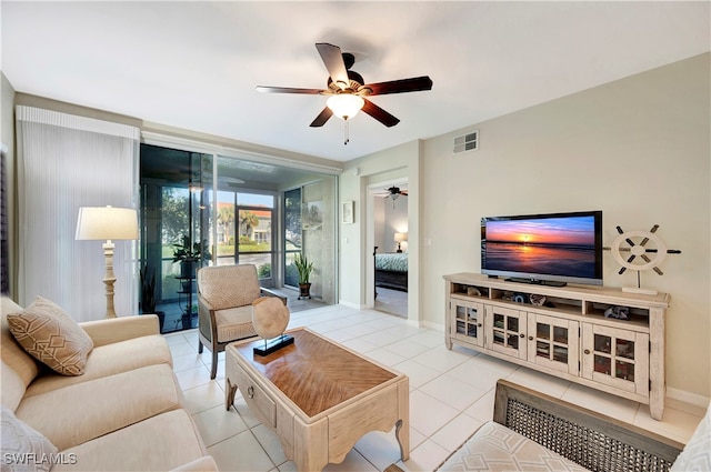 living room featuring ceiling fan and light tile patterned flooring