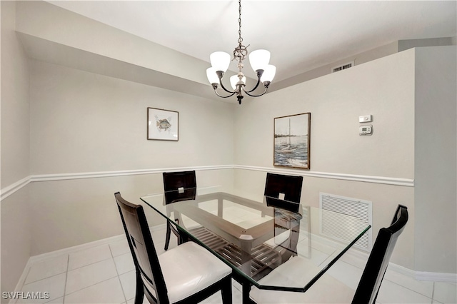 tiled dining area featuring a notable chandelier