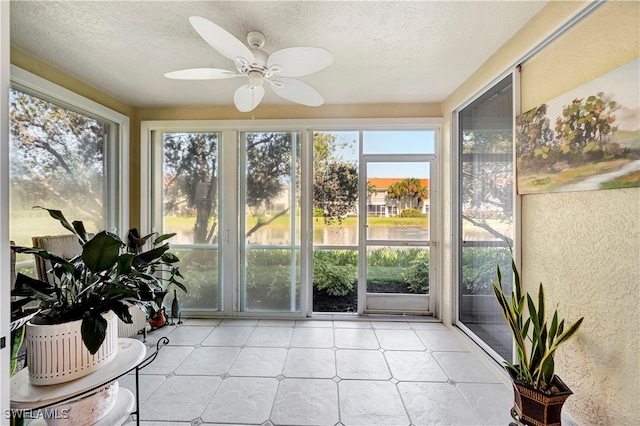 sunroom featuring ceiling fan