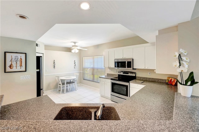 kitchen featuring white cabinets, sink, ceiling fan, light tile patterned flooring, and stainless steel appliances